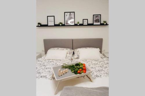 a bedroom with a bed with a tray of vegetables on it at LEON Apartment NEU! Gemütlichkeit an erster Stelle in Linz