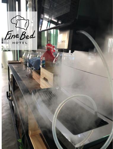 a counter in a kitchen with smoke coming out of it at Fine Bed Hotel in Nonthaburi
