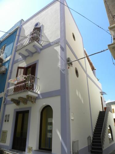 a white building with two balconies and two stairs at Case Vacanze Albamarina in Lipari