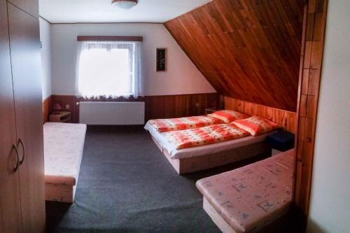 a small room with two beds and a window at Apartment Rokytnice nad Jizerou 6 in Hranice