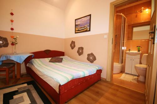 a small bedroom with a bed and a bathroom at Pokoje Klaudia in Darłowo