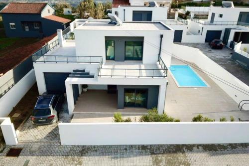 an aerial view of a house with a swimming pool at New and modern 3 bedroom Villa with private heated pool near Nazaré in São Martinho do Porto