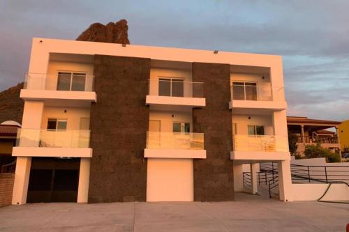 a building in front of a mountain at Departamento Turquesa 3 joyas de mar San Carlos in San Carlos