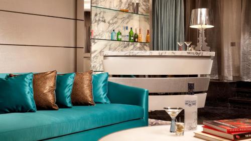 a living room with a blue couch and a table at Hotel Indigo Shanghai On The Bund by IHG in Shanghai