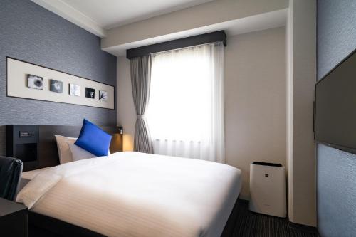 Una cama o camas en una habitación de Goi Grand Hotel