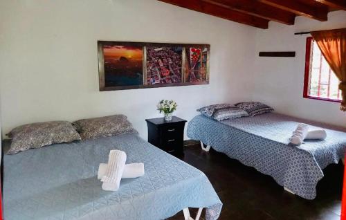 Giường trong phòng chung tại Casa Roja Parche Campestre - Hospedaje Guatapé