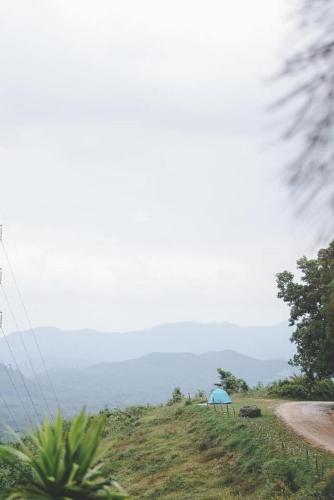 a blue tent on the side of a hill at Por Sampao Camp&Resort in Ban Pha Saeng Lang