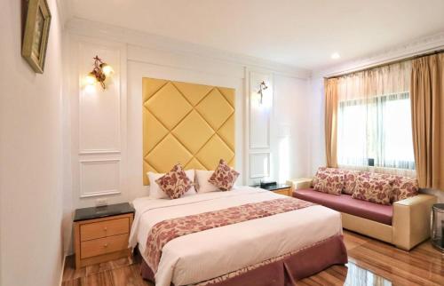 a hotel room with a bed and a couch at 里夏民宿.墾丁後壁湖 in Hengchun