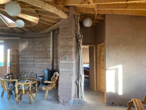 una stanza con tavolo e sedie in una stanza di Vernacular Lodge a San Pedro de Atacama