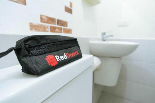 a black bag sitting on a counter next to a sink at RedDoorz Plus @ Cibogo Puncak 3 in Bogor