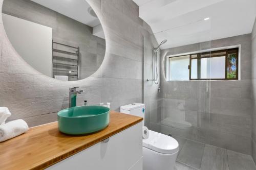 a bathroom with a sink and a toilet at The Noosa Apartments in Noosa Heads