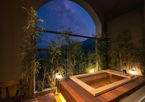 a bath tub in a room with a window at KensingtonResort JirisanHadong in Hadong