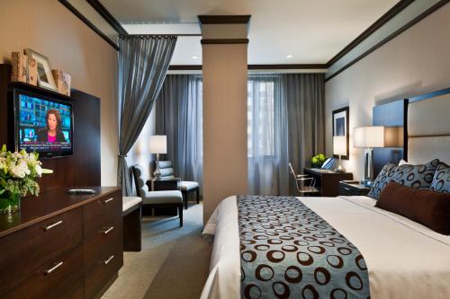a hotel room with a bed and a living room at The Pearl Hotel in New York