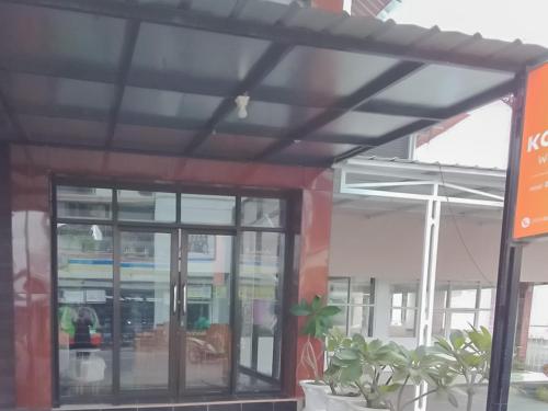 awning over a building with windows and plants at Koolkost near DPRD Kabupaten Subang in Subang