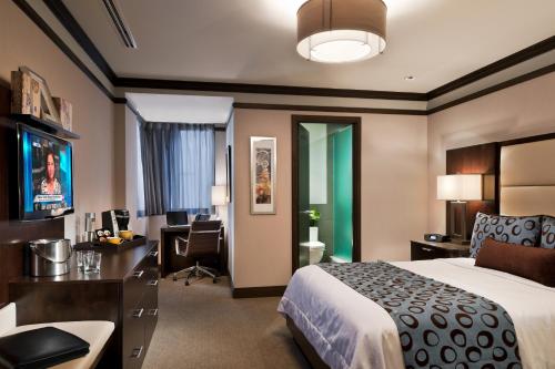 a hotel room with a bed and a desk at The Pearl Hotel in New York
