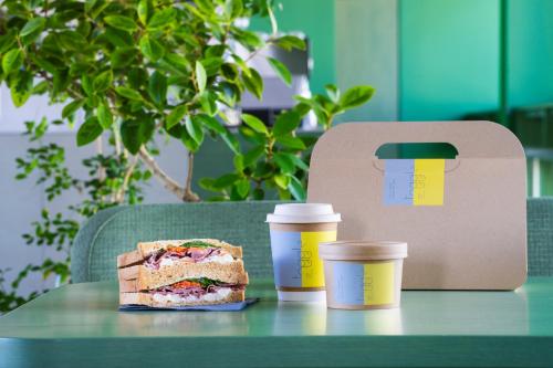 a table with a sandwich and two cups of coffee at toggle hotel suidobashi TOKYO in Tokyo