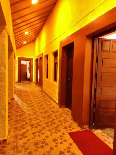 an empty hallway of a building with a door at KSTDC Hotel Mayura Gerusoppa, Jogfalls in Māvingundi