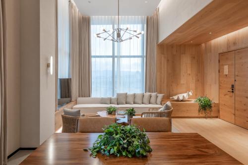 a living room with a table and a couch at 1 Hotel Haitang Bay, Sanya in Sanya