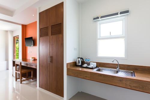 a kitchen with a sink and a window at Parida Resort in Bang Tao Beach