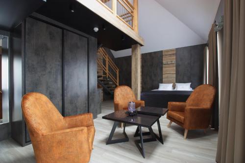 a room with two chairs and a table and a bed at Aparton in Ustka