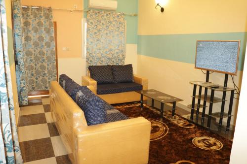a living room with a couch and a chair at RESIDENCE AMAR in Douala