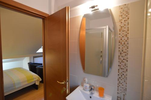 a bathroom with a sink and a mirror at GrandVille Apartments in Bucharest