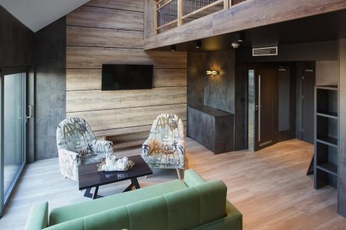 a living room with a green couch and a table at Aparton in Ustka