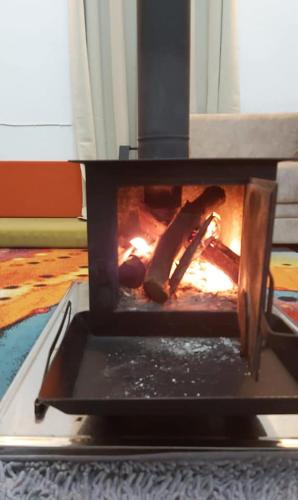 a stove with a fire inside of it at Mandala in Mount מנדלה בחרמון סוויטה in Majdal Shams