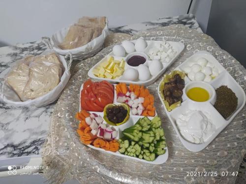 a tray of food with eggs and vegetables on a table at Mandala in Mount מנדלה בחרמון סוויטה in Majdal Shams