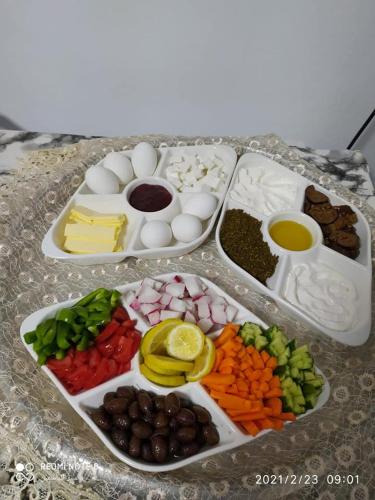 a table topped with different types of vegetables and eggs at Mandala in Mount מנדלה בחרמון סוויטה in Majdal Shams