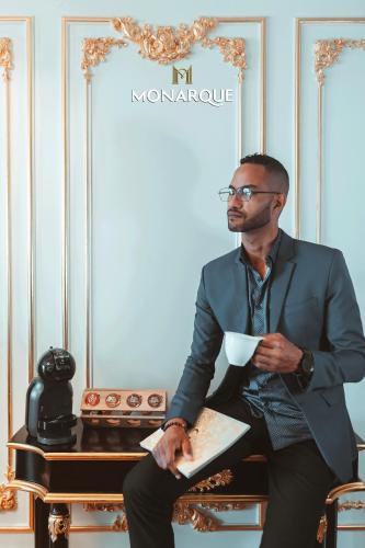 a man in a suit sitting at a table with a bowl at Monarque Hotel Danang in Da Nang