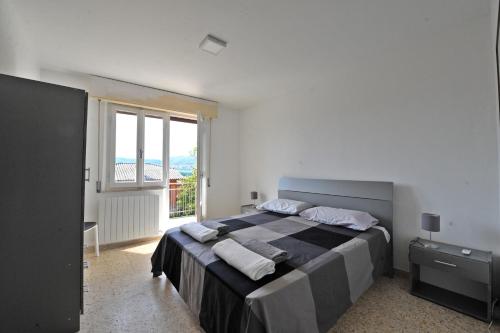 a bedroom with a large bed and a large window at Casa Marconi in Tuoro sul Trasimeno