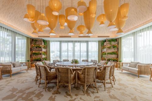 a large dining room with a table and chairs at 1 Hotel Haitang Bay, Sanya in Sanya