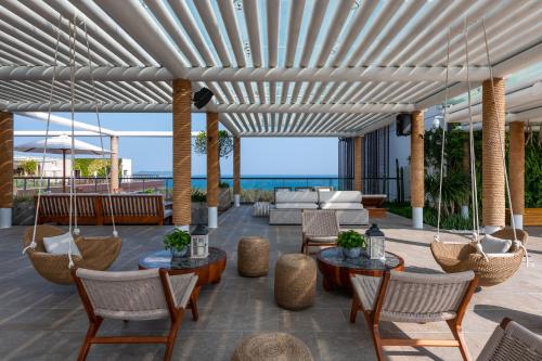 an outdoor patio with a white pergola at 1 Hotel Haitang Bay, Sanya in Sanya