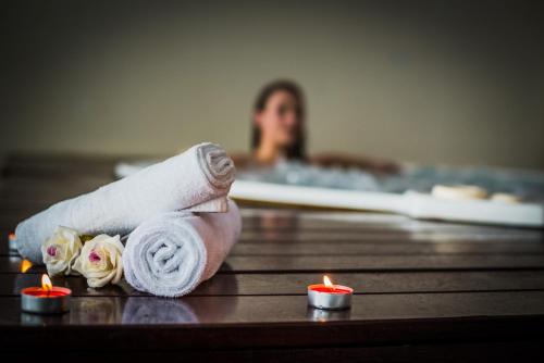 a rolled up towel and candles in a bathroom at Hotel Kaj in Marija Bistrica