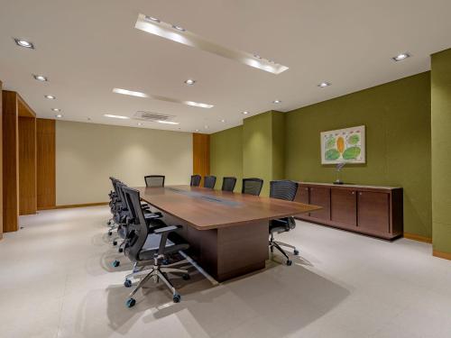 a conference room with a wooden table and chairs at LOTTE Hotel Serviced Apartment in Yangon