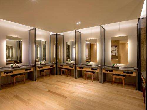 a row of sinks in a bathroom with mirrors at LOTTE Hotel Serviced Apartment in Yangon
