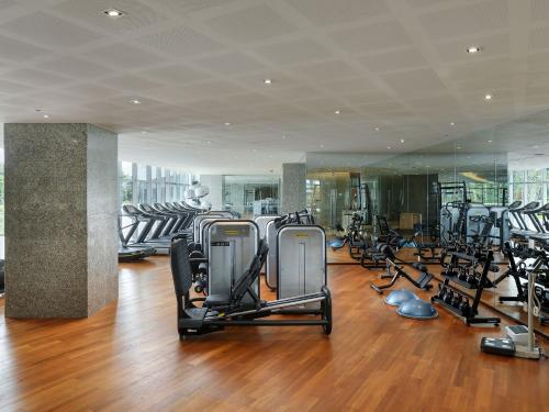 a gym with rows of treadmills and exercise bikes at LOTTE Hotel Serviced Apartment in Yangon