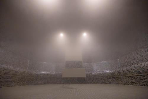 a foggy arena with two lights on top of it at Hotel Belmont & Spa in Sinaia
