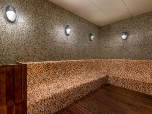 a room with a brick wall with lights on it at LOTTE Hotel Serviced Apartment in Yangon
