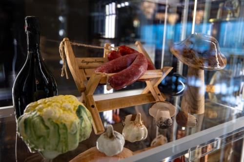 a display case with sausage and other food items at Hotel Belmont & Spa in Sinaia