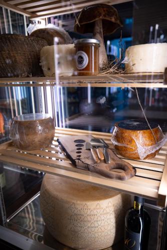 a shelf with bread and other items on it at Hotel Belmont & Spa in Sinaia