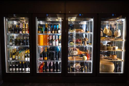 a refrigerator filled with lots of different types of drinks at Hotel Belmont & Spa in Sinaia