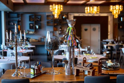 a teddy bear standing on a table in a restaurant at Hotel Belmont & Spa in Sinaia