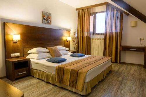 a hotel room with a large bed and a window at Boutique Hotel L do Rado in Sofia