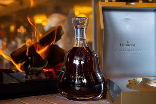 a bottle of humanity parolis sitting next to a fireplace at Hotel Belmont & Spa in Sinaia