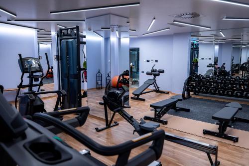 a gym with treadmills and machines in a room at Hotel Belmont & Spa in Sinaia