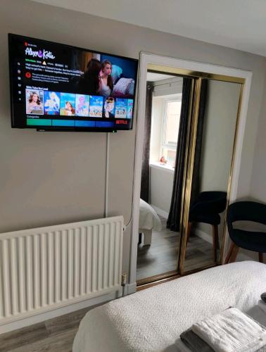 a bedroom with a flat screen tv on the wall at Anchors Away in Ayr