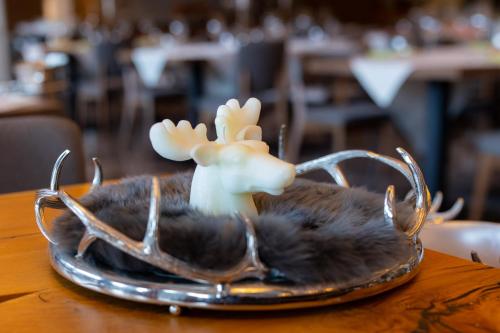 a plate with a deer head and antlers on a table at Hotel Belmont & Spa in Sinaia