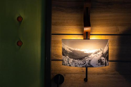 a lamp with a picture of a wave on a wall at Hotel Belmont & Spa in Sinaia